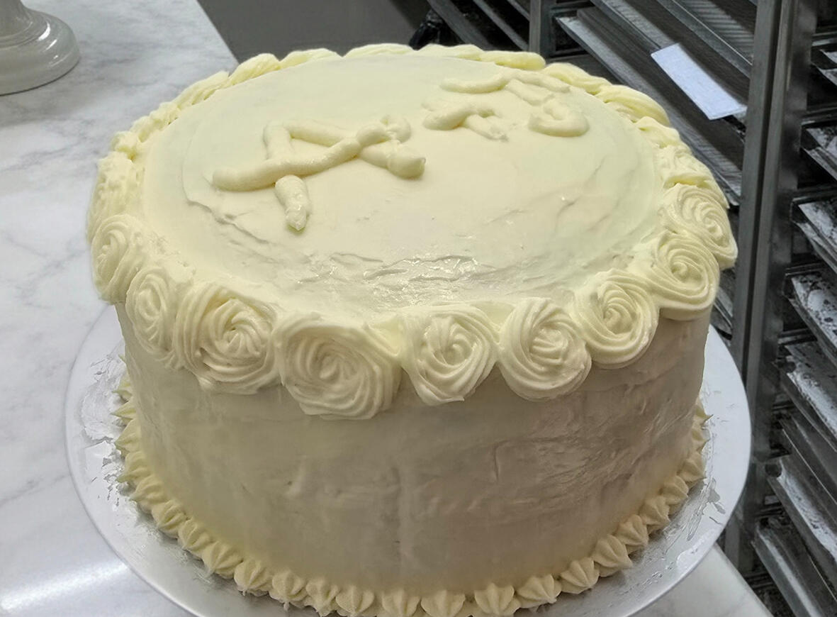 Classic vanilla layer cake with buttercream rosette border