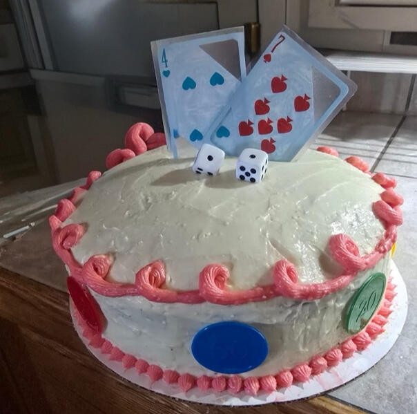 Playing card themed birthday cake with card and dice toppers and polka dot accents